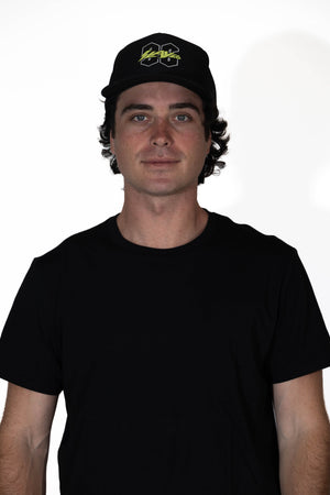 Man wearing a black cap and black t-shirt against a white background
