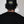 Person wearing a black cap with a logo on the back against a white background