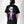 Person wearing a black t-shirt with a colorful skeleton design on the back, standing against a white background. Halloween frankenstein